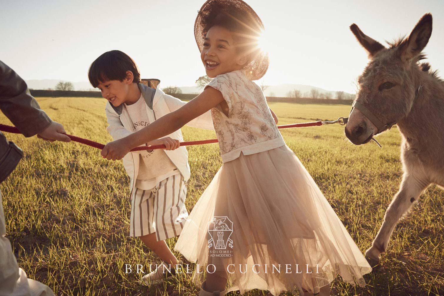 Brunello Cucinelli kids campaign Italian luxury brand - children donkey countryside golden hour - photographer Federico Leone