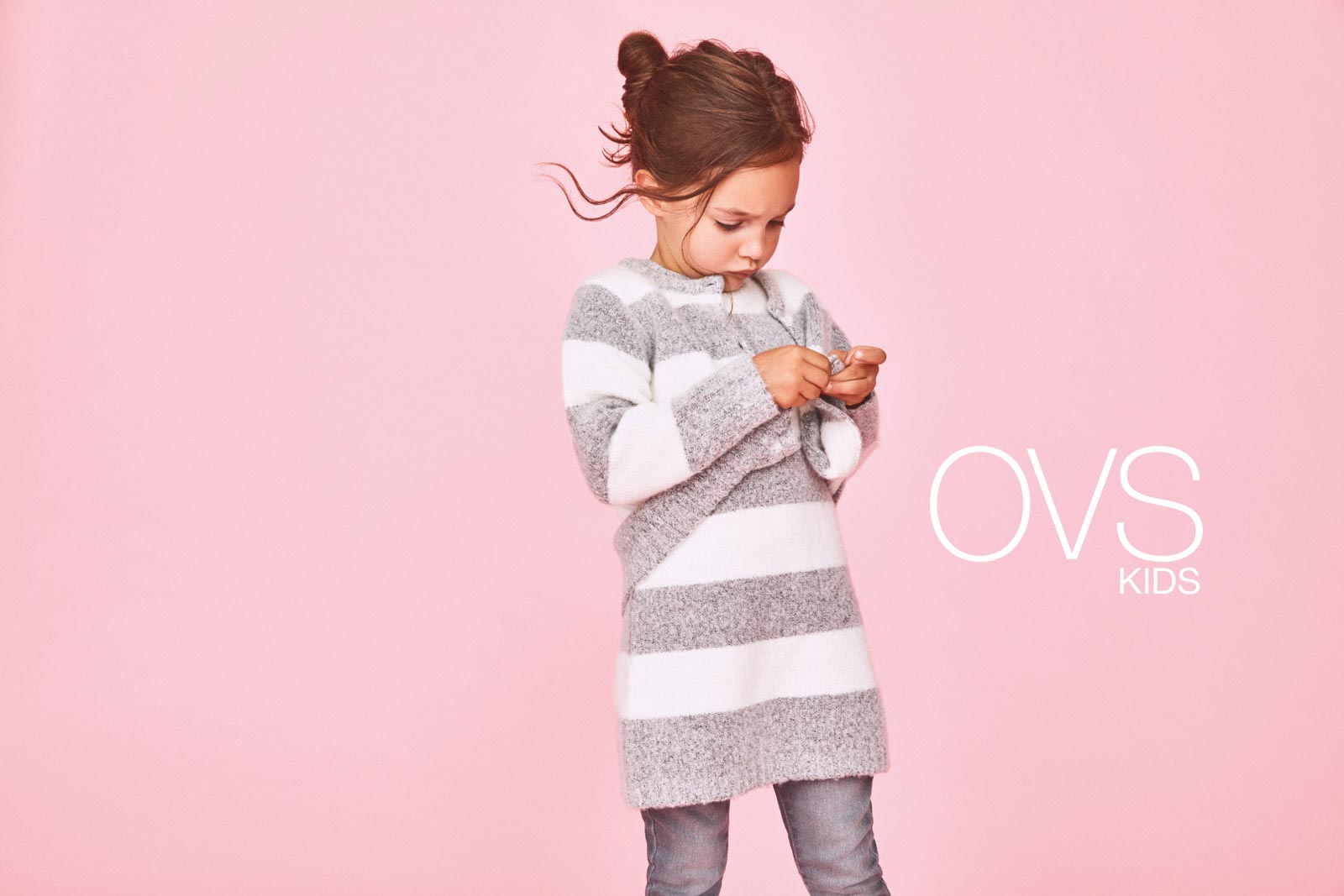 OVS Kids campaign Italian brand - girl grey white striped sweater pink background - photographer Federico Leone